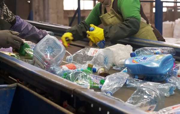 Sorting home recyclable materials at a recycling center