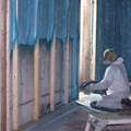Closed cell spray foam insulation being applied to basement walls
