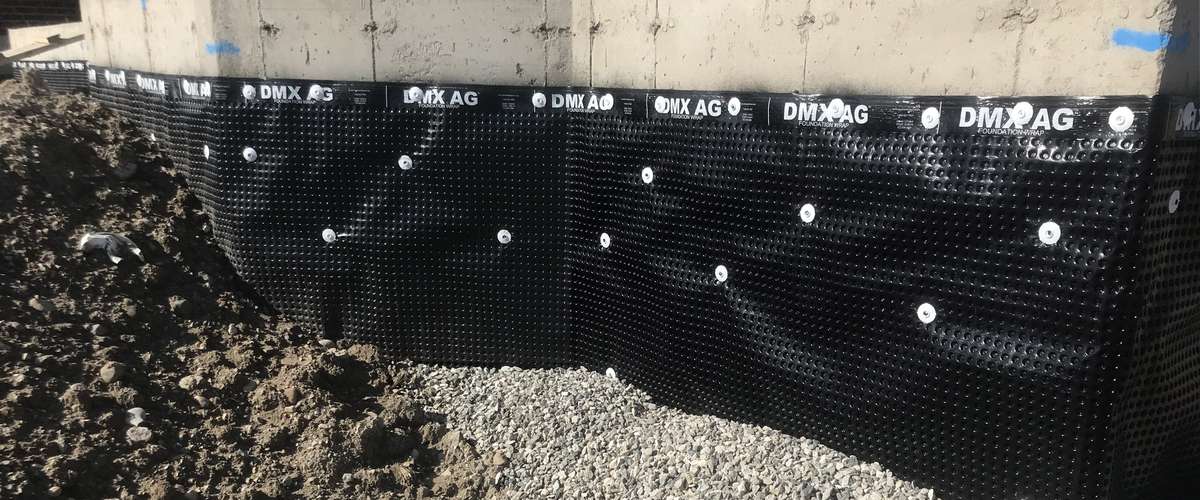 Basement foundation with exterior dimple membrane for water protection