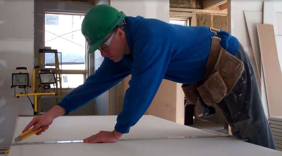 Installing recycled drywall in the Edelweiss House
