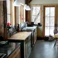 Bathroom with refinished claw foot tub and barn board trim in a home c