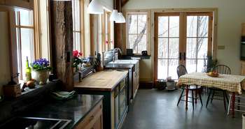 Bathroom with refinished claw foot tub and barn board trim in a home c