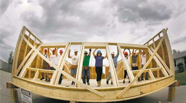 Habitat workers raise a wall at the the Red River Ex June 2011