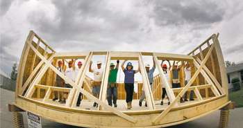 Habitat workers raise a wall at the the Red River Ex June 2011