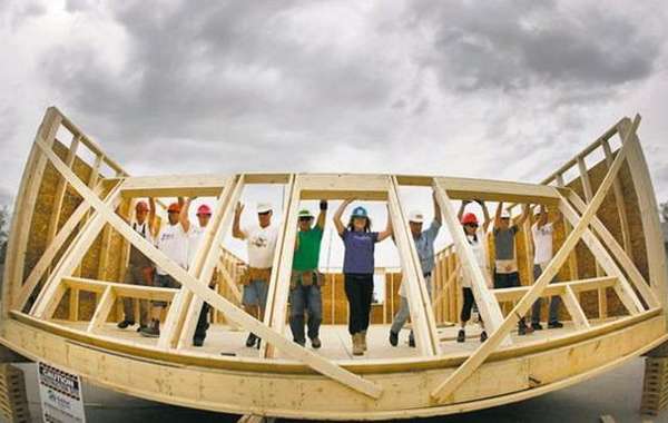 Habitat workers raise a wall at the the Red River Ex June 2011