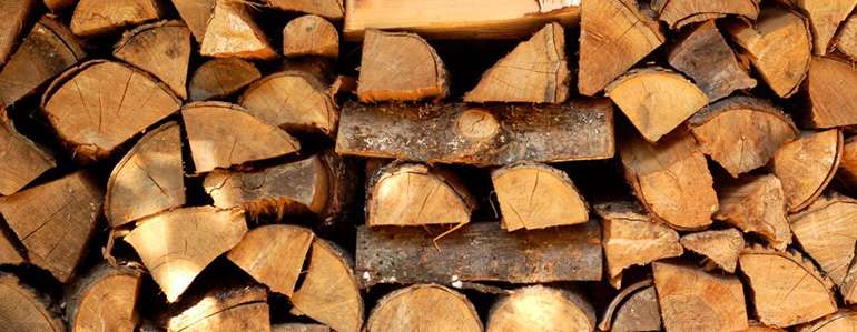 Stacked firewood ready for a nice hot fire at home © Ecohome
