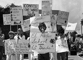 April 22, 1970: Sixth-grader Brad Frank, 11, wearing a gas mask, joins about 100 classmates during an Earth Day march on Wilshire Boulevard. (George Fry / Los Angeles Times) 