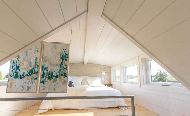 Natural light in spacious tiny House loft bedroom