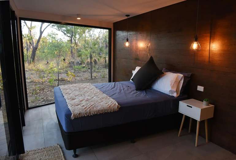 Tiny house bedroom in this shipping container home is spacious