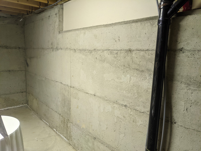 Insulating bare concrete basement walls with rigid foam panels 