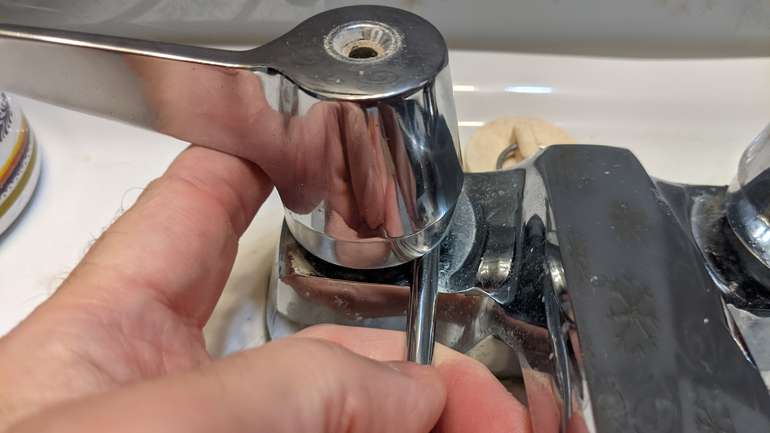Carefully levering up the tap top off the cartridge is the next step in fitting a new tap washer