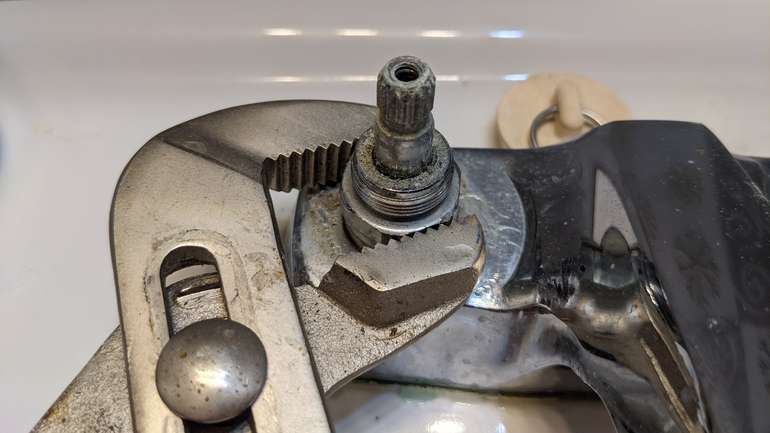 How to unscrew a faucet cartridge with plumbers grips to repair a drip