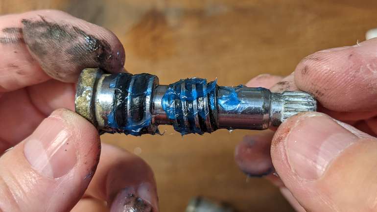 This is the faucet mechanism with fresh grease ready to screw back into the bore of the cartridge