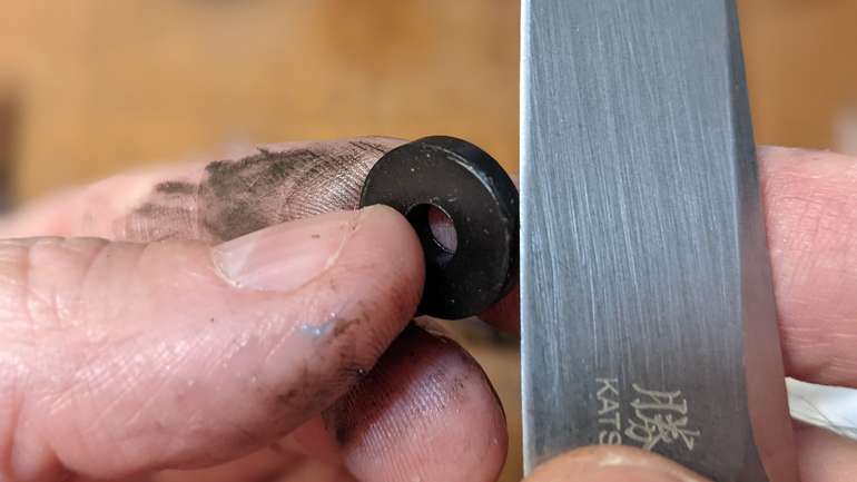 If the new sealing washer has any excess rubber around the edge, trim it carefully with a sharp knife so it can seat well