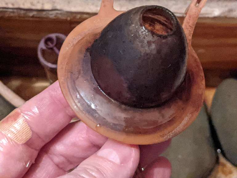 The old toilet flapper that we are going to replace, you can see the mark where it was missing the valve seat