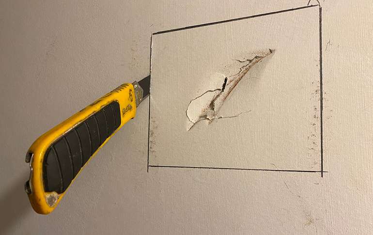 To fix a hole in drywall, use a utility knife to cut out the damaged section.
