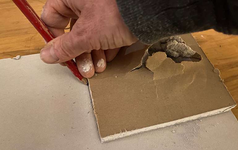 take the removed damaged piece of drywall to trace a replacement piece.