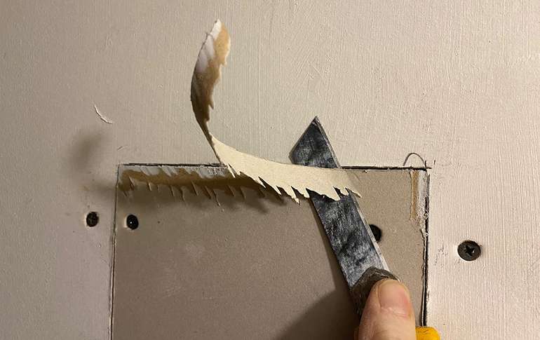 If the new piece of drywall protrudes, trim it with a utility knife. 