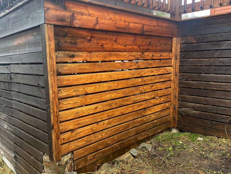 Old neglected cedar deck siding boards after cleaning off carefully with a pressure washer to restore the color 