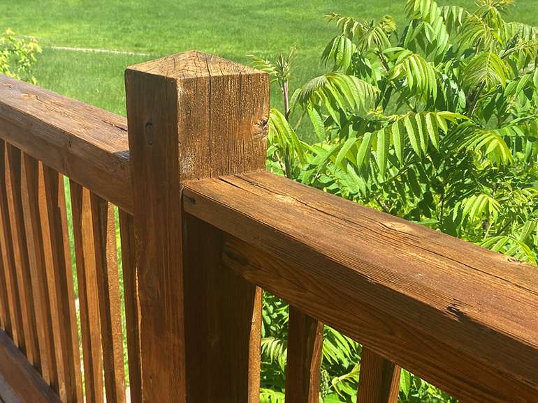 Staining a cedar deck to look like new - After photo of the newly stained deck railing