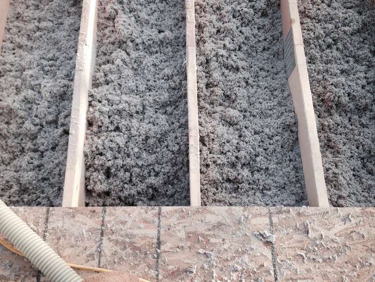 Loose fill cellulose insulation in a roof has a reduced embodied carbon rating