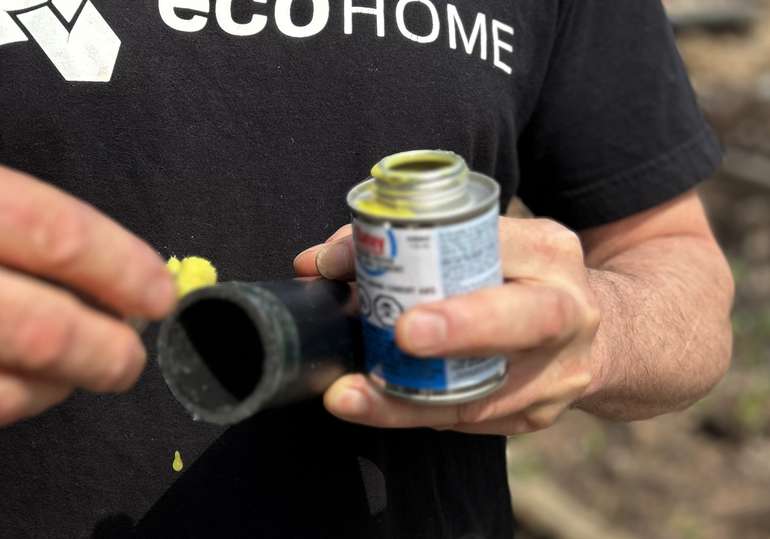 Put ABS glue on a drain pipe to attached an elbow or union joints.. - Image © Mike Reynolds