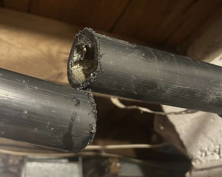 ABS pipe can be cut easily with a hand saw or hack saw when doing basic plumbing repairs - Image © Mike Reynolds