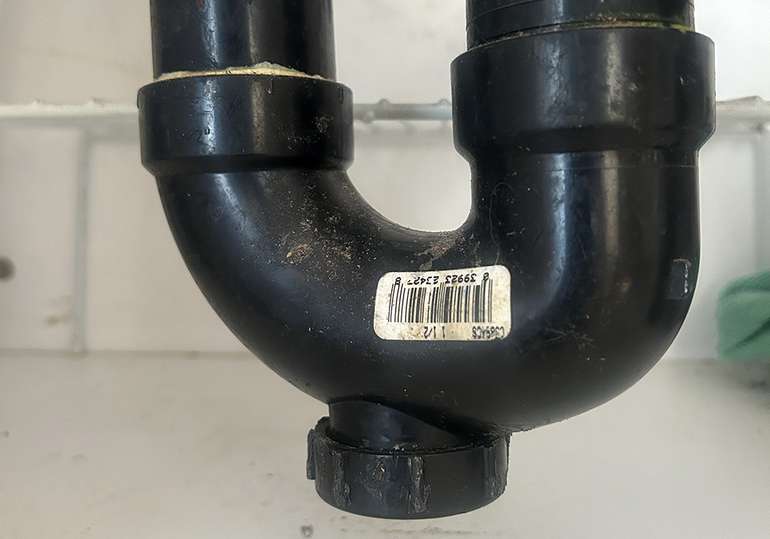 To unclog a sink drain, the first thing to check is if the P-Trap is full, so remove the drain plug at the bottom. - Image © Mike Reynolds