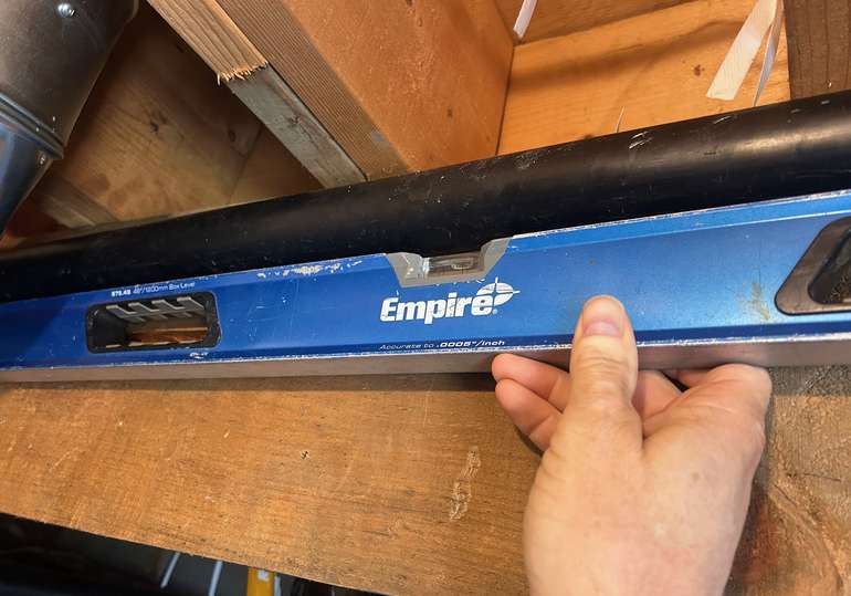 A level can be used to ensure a 1/4 inch per foot slope for kitchen and bathroom sink drains - Image © Mike Reynolds
